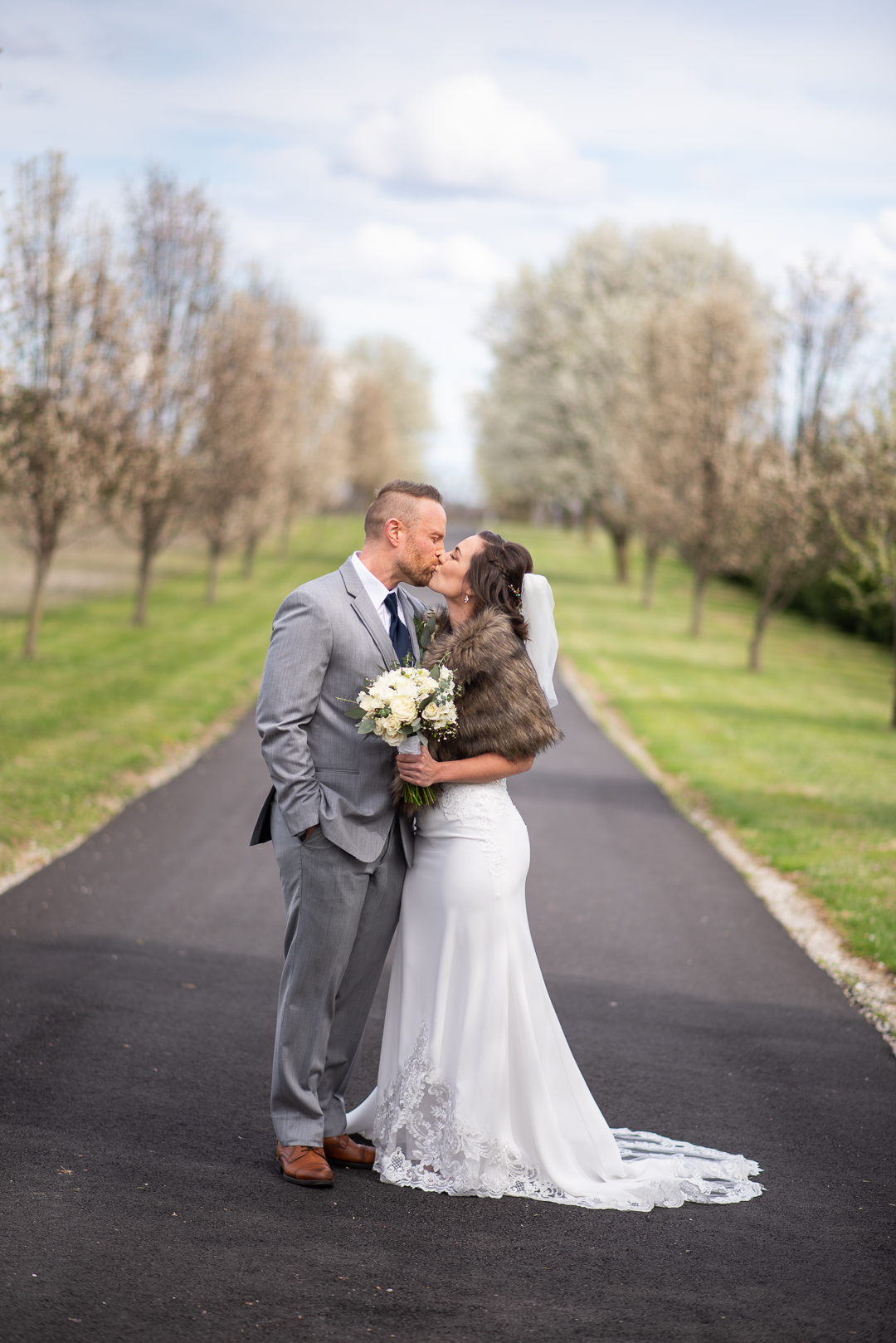 Maryland wedding couple kiss by flowering trees